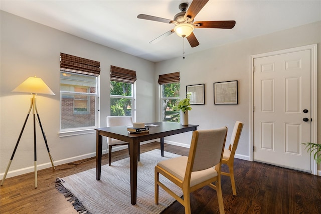 dining area with ceiling fan and dark wood-type flooring