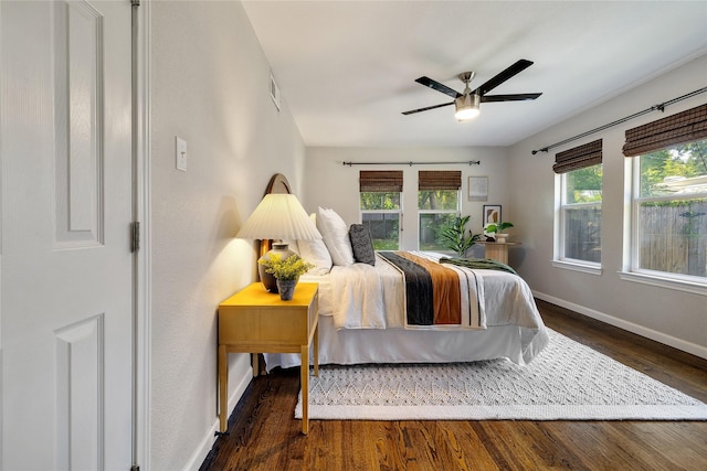 bedroom with ceiling fan and dark hardwood / wood-style floors