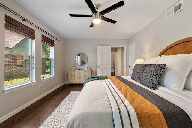 bedroom with ceiling fan and dark wood-type flooring