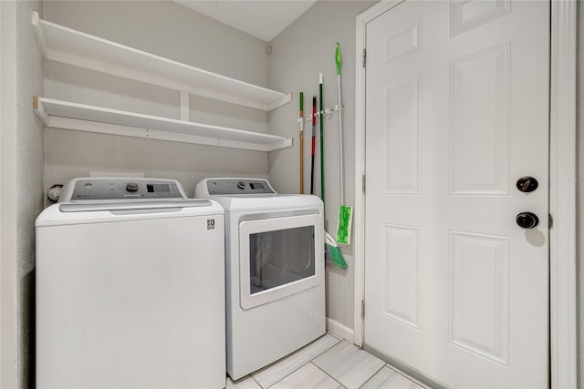 washroom featuring light tile patterned floors and washing machine and dryer