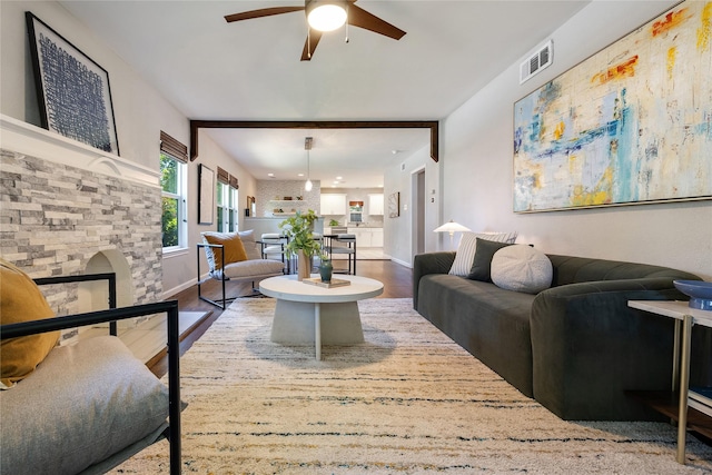 living room with ceiling fan and wood-type flooring