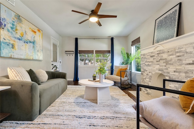 living room featuring ceiling fan and hardwood / wood-style flooring