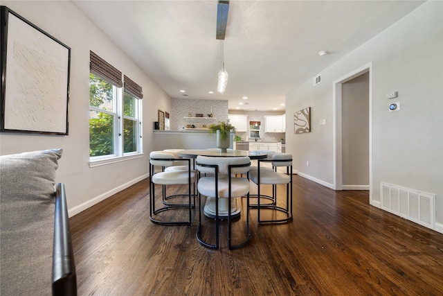 dining space featuring dark hardwood / wood-style floors