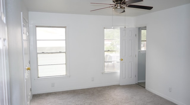 unfurnished room with light carpet, plenty of natural light, and ceiling fan