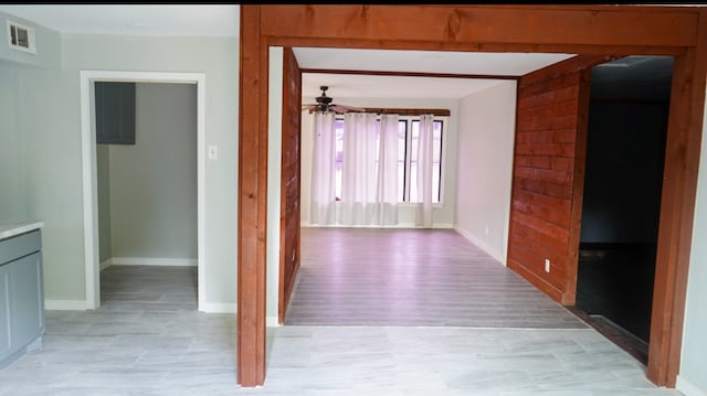 hallway with light wood-type flooring and beamed ceiling