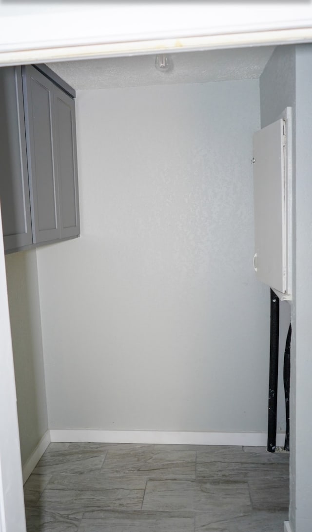 laundry room with dark tile patterned flooring