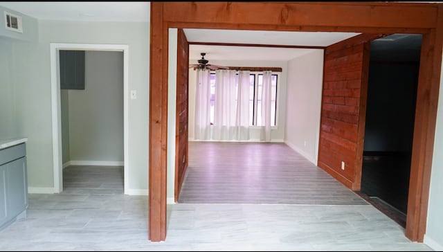 hall featuring beam ceiling and light hardwood / wood-style floors