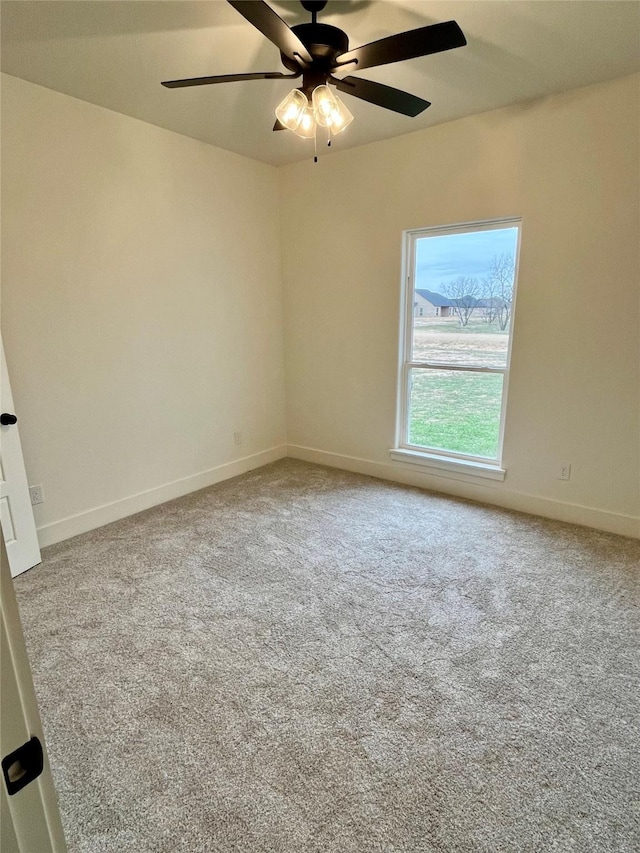 spare room featuring carpet floors and ceiling fan