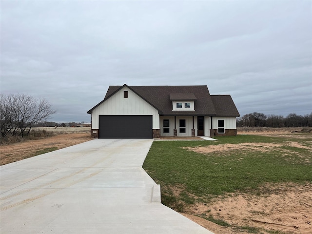 view of front of house with a garage and a front yard