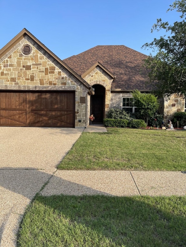 view of front of property with a garage and a front yard