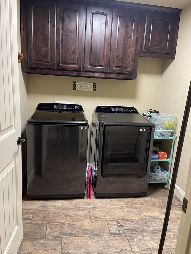 laundry room featuring cabinets and washer and dryer