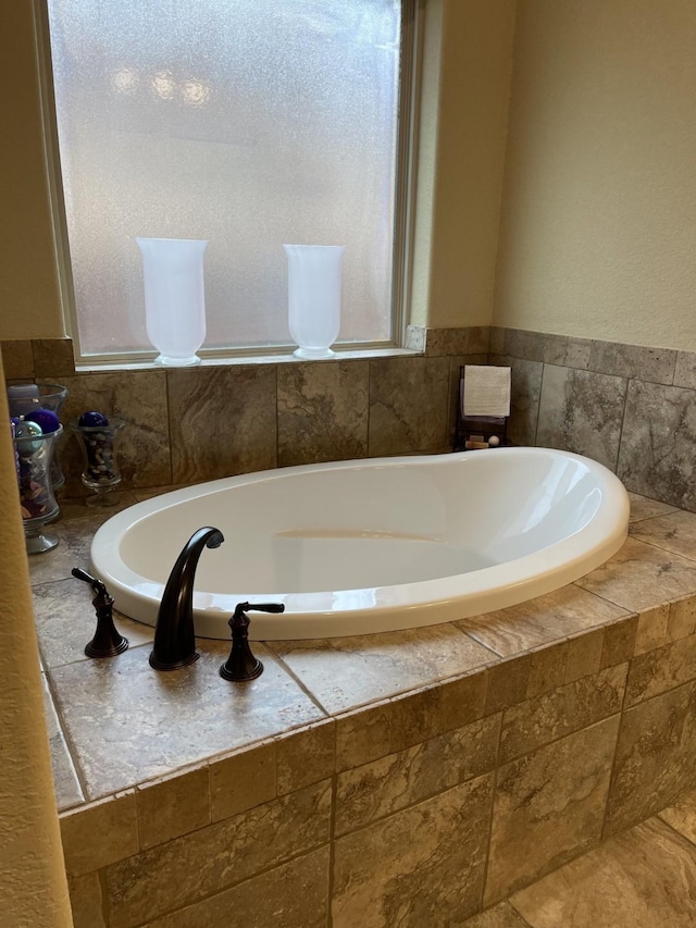 bathroom with a bath and a healthy amount of sunlight