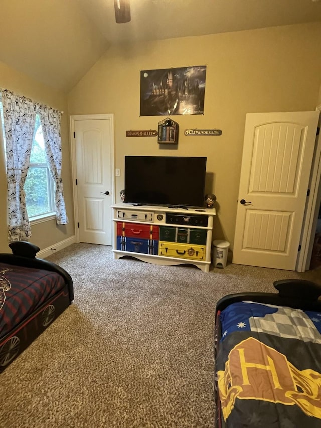 bedroom with ceiling fan, carpet floors, and lofted ceiling