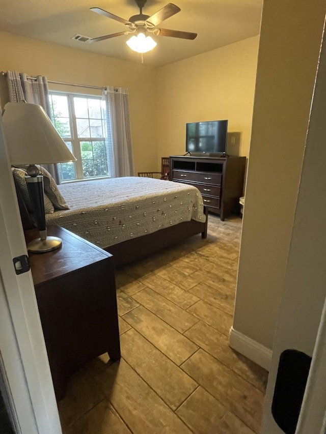 bedroom with ceiling fan and light hardwood / wood-style flooring