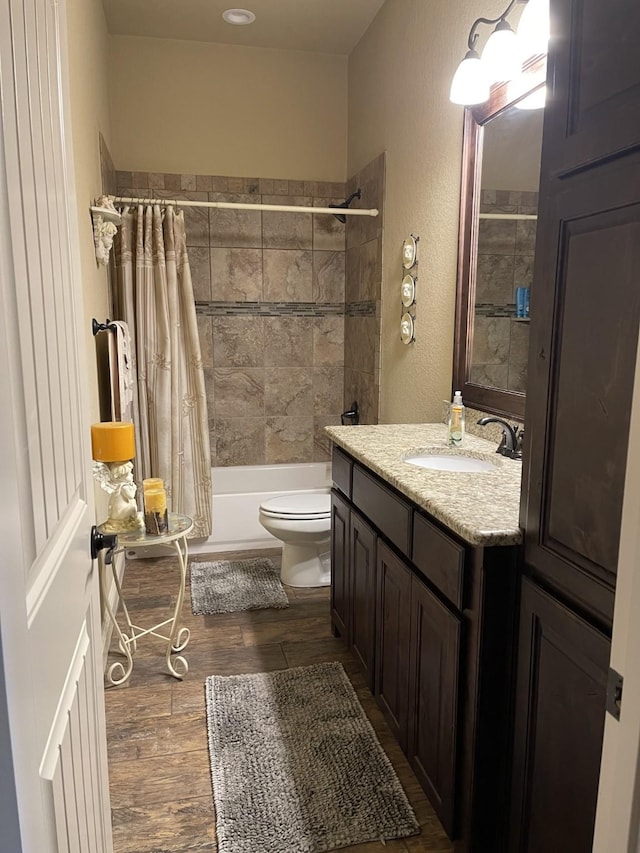 full bathroom with toilet, vanity, shower / bath combo with shower curtain, and hardwood / wood-style floors