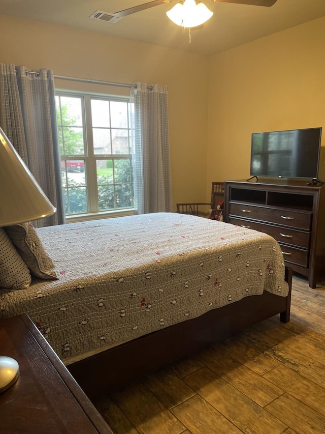 bedroom with ceiling fan and wood-type flooring