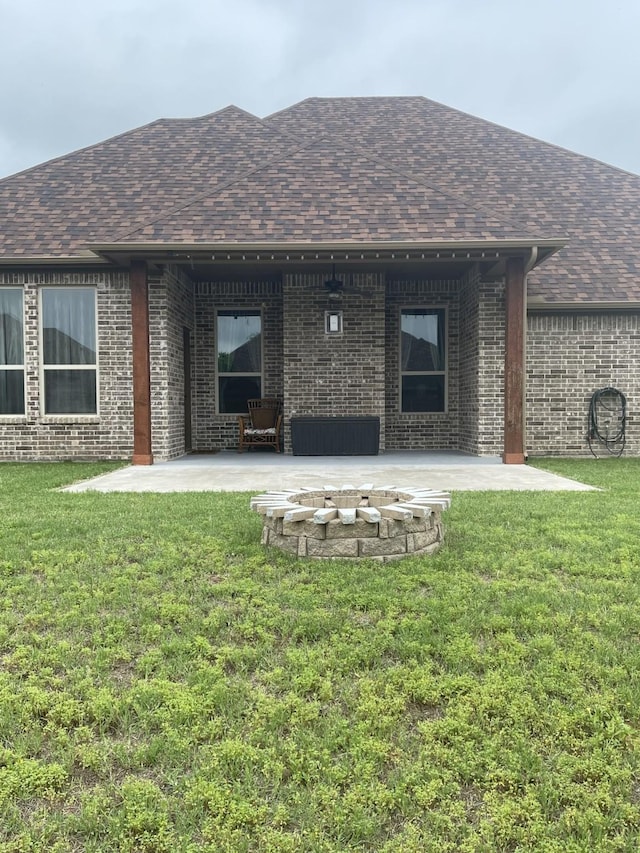 rear view of house with a lawn and a patio area