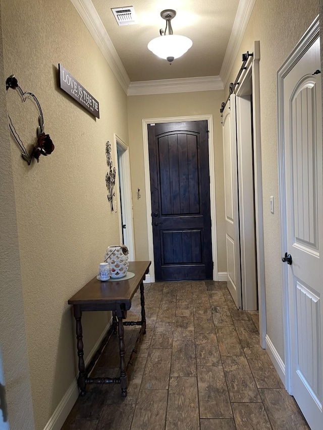 doorway to outside with a barn door and ornamental molding