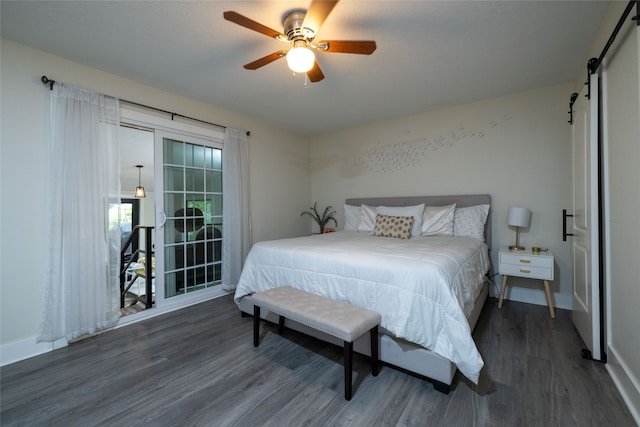 bedroom featuring a barn door, ceiling fan, and dark hardwood / wood-style flooring