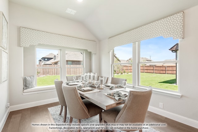 dining space with dark hardwood / wood-style floors and vaulted ceiling