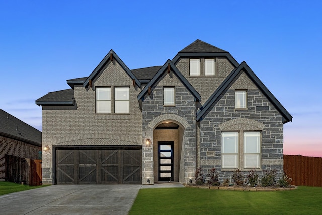 view of front facade with a garage and a lawn