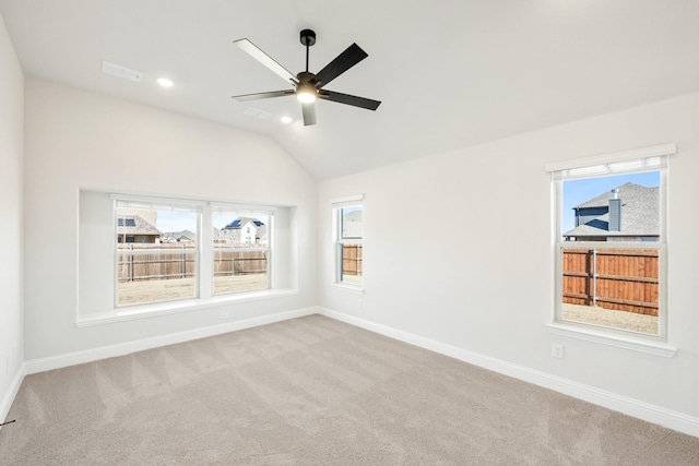 spare room featuring carpet, lofted ceiling, and ceiling fan