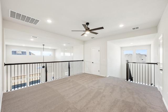 spare room with carpet floors and ceiling fan