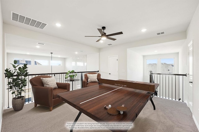 recreation room featuring light colored carpet