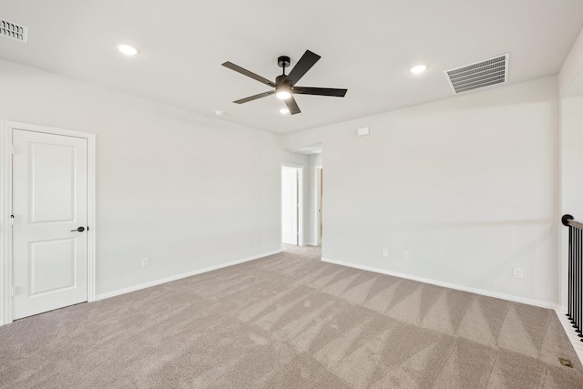 carpeted spare room featuring ceiling fan