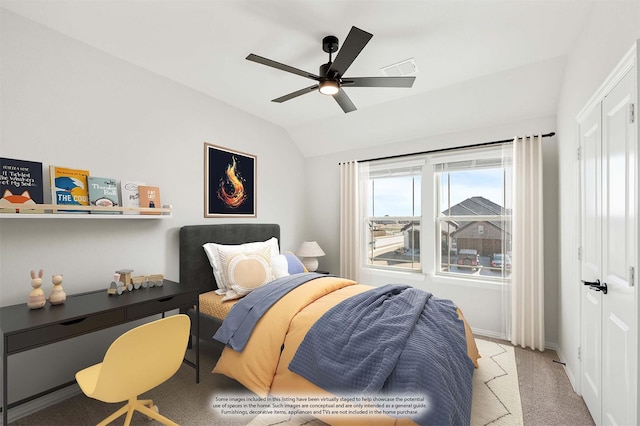 carpeted bedroom with ceiling fan and lofted ceiling