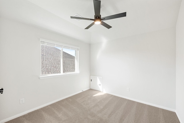 carpeted spare room with ceiling fan