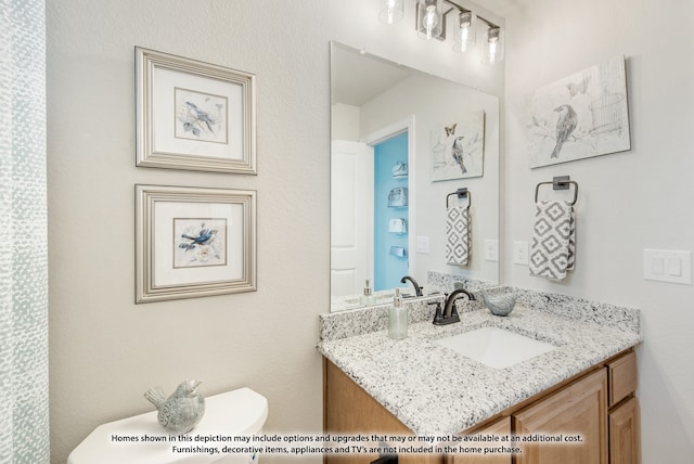 bathroom with vanity and toilet