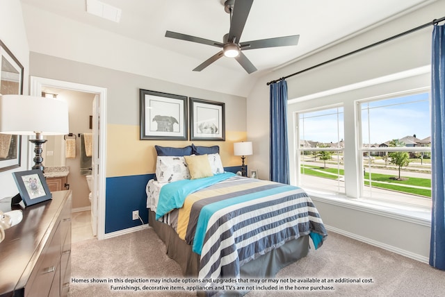 carpeted bedroom with ensuite bath, ceiling fan, and vaulted ceiling