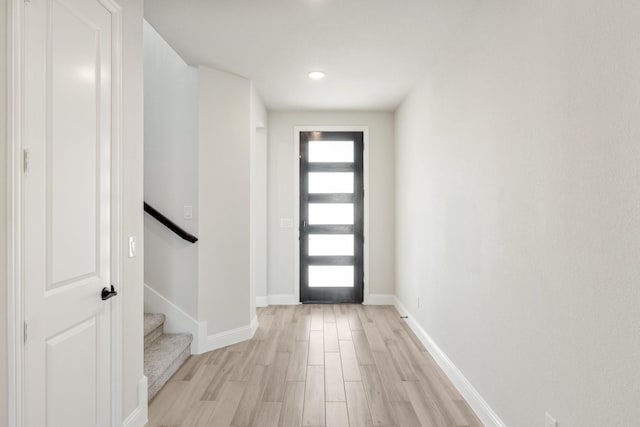 foyer entrance with light hardwood / wood-style floors