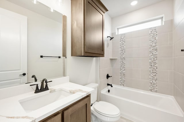 full bathroom featuring vanity, tiled shower / bath combo, and toilet