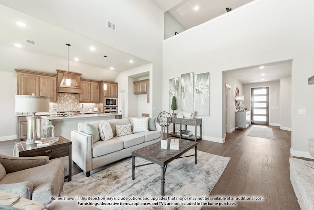 living room featuring high vaulted ceiling and light hardwood / wood-style floors