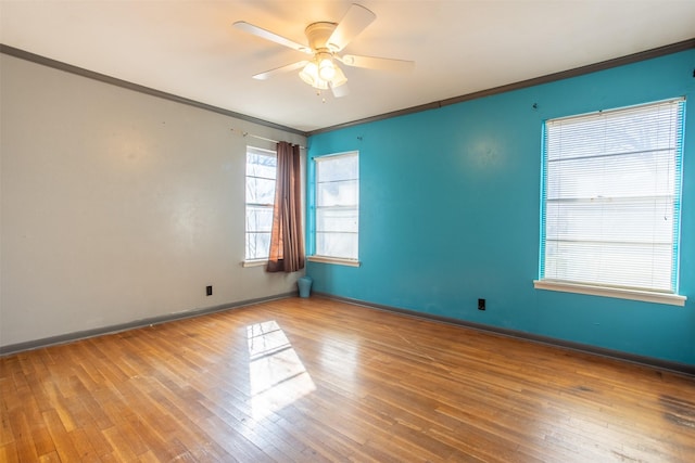 empty room featuring crown molding, wood-type flooring, and ceiling fan