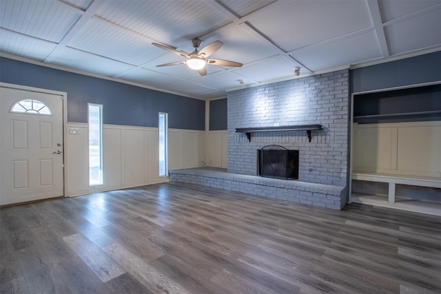 unfurnished living room featuring coffered ceiling, ceiling fan, wood-type flooring, and a fireplace