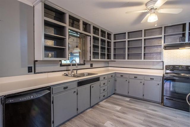 kitchen featuring gray cabinets, decorative light fixtures, sink, light hardwood / wood-style floors, and black appliances