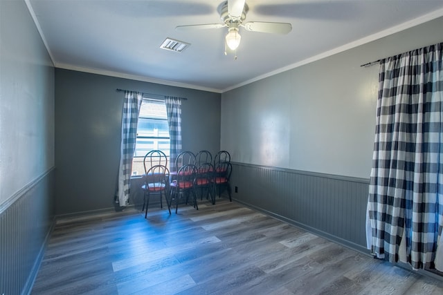 spare room with wood-type flooring, ceiling fan, and crown molding