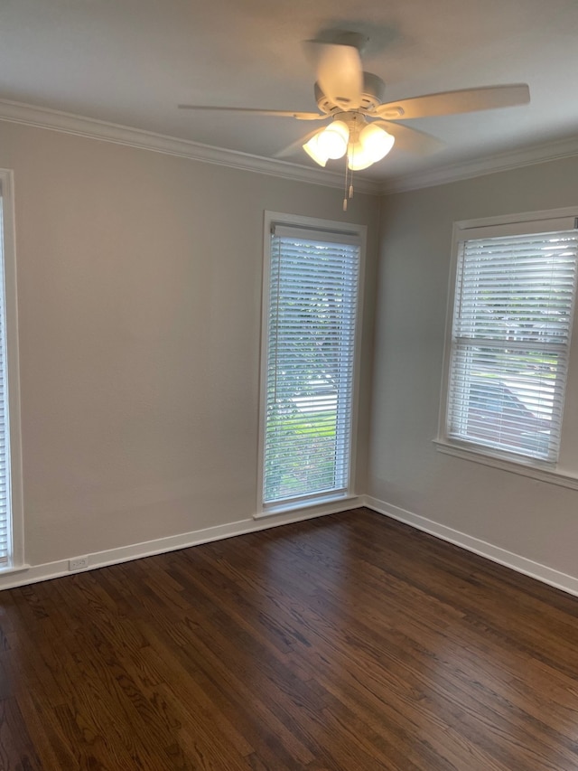 empty room with dark hardwood / wood-style flooring, ornamental molding, and ceiling fan