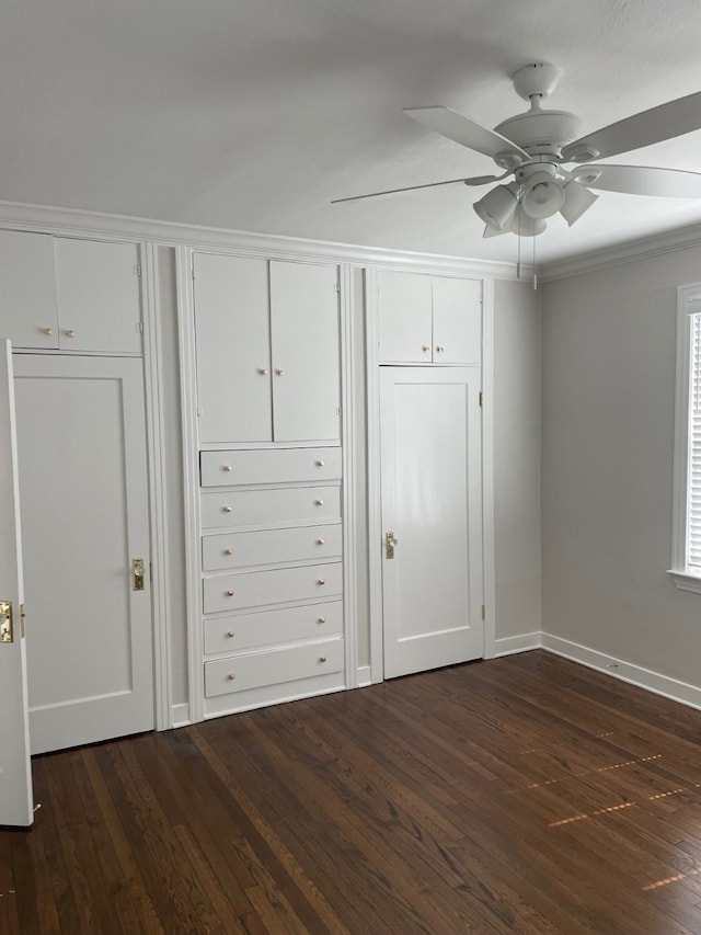 unfurnished bedroom featuring ceiling fan, ornamental molding, and dark hardwood / wood-style floors