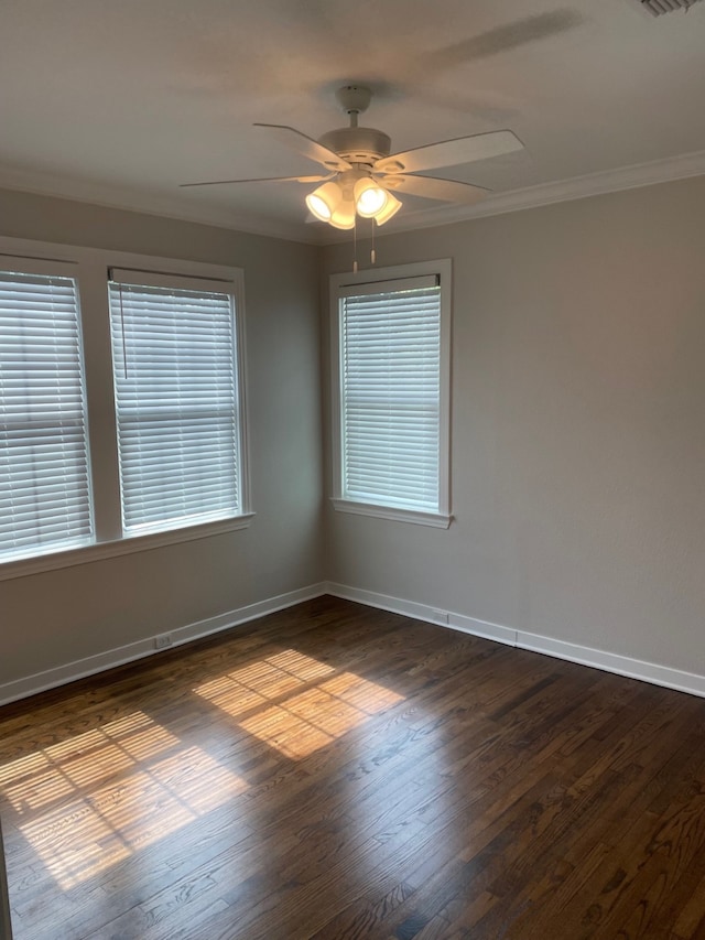 empty room featuring ornamental molding, dark hardwood / wood-style floors, and ceiling fan