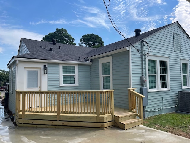 back of house featuring a wooden deck and central air condition unit