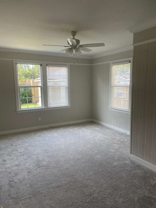 unfurnished room with crown molding, light colored carpet, and ceiling fan