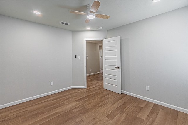 empty room featuring ceiling fan and hardwood / wood-style floors