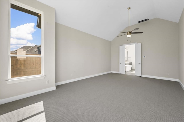 carpeted empty room featuring vaulted ceiling and ceiling fan