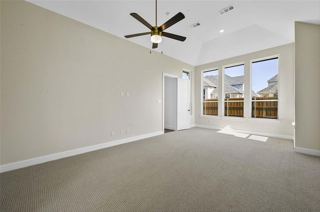 carpeted spare room with vaulted ceiling and ceiling fan