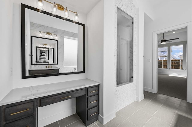 bathroom featuring tile patterned flooring, vanity, and ceiling fan