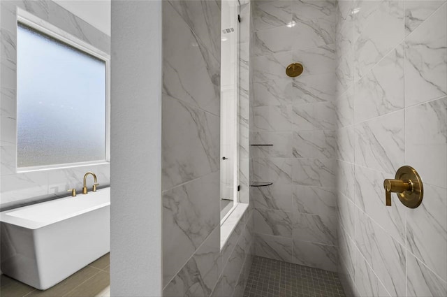 bathroom with tile walls and tiled shower